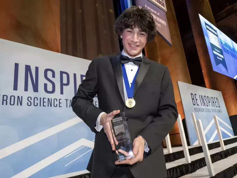 an image of Matteo Paz, receiving an award for his high school passion project "VARnet"