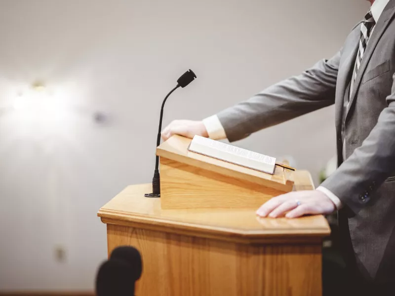 Speaker at a podium presenting policy speech topics for college students 